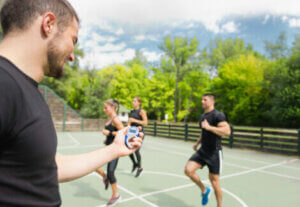 A coach timing a training group.