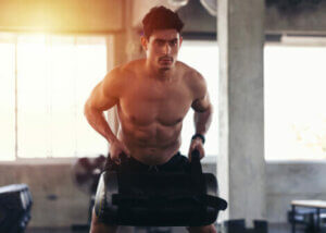 A man lifting a sandbag.