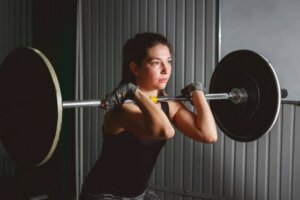 A woman lifting a barbell.