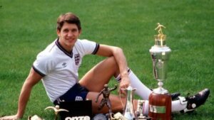 Gary Linekar sitting with his trophies.