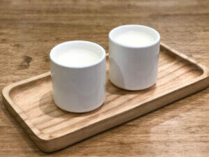 Two mugs of warm milk.