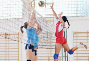 Women playing volleyball.