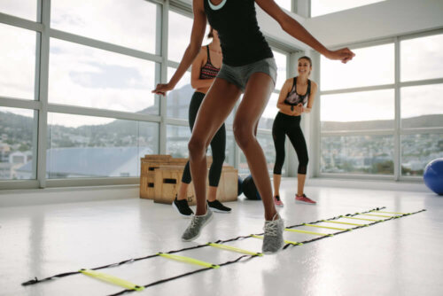 A woman training with an agility ladder.