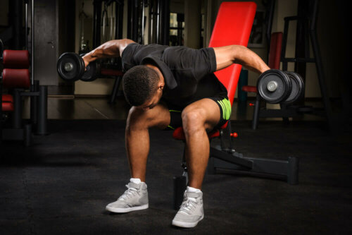 A man doing the bird-dog exercise.