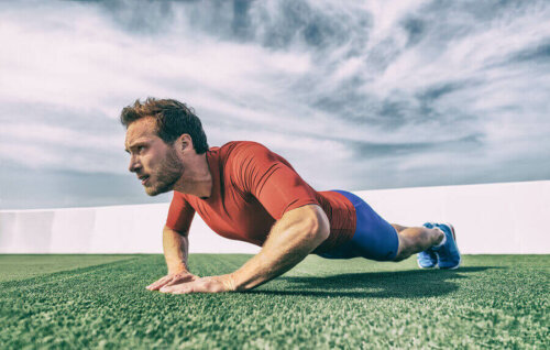A man doing diamond push-ups, one of the greatest CrossFit exercises.