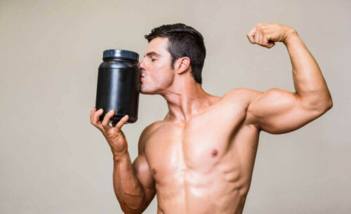 A man kissing a bottle of protein powder.