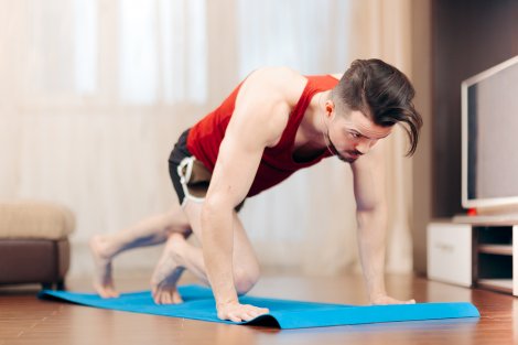 A man doing mountain climbers during a functional training circuit