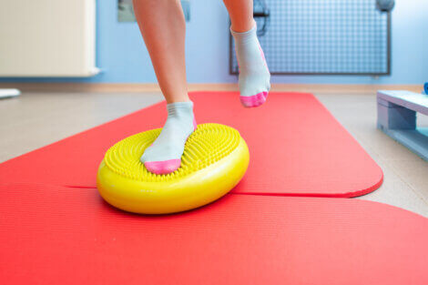 Doing proprioceptive exercises on top of a balance trainer