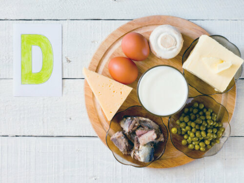 Different foods with vitamin D on a circular cutting board including dairy products, eggs, meat.