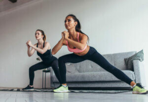 Two women doing a workout routine.