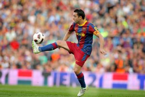 Xavi Hernandez playing soccer on the field.