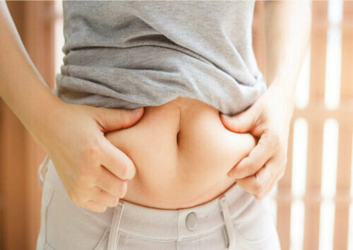 A woman grabbing her belly.