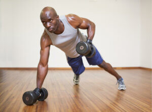 Man exercising with weights at home
