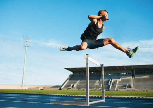 A man running a hurdle race.