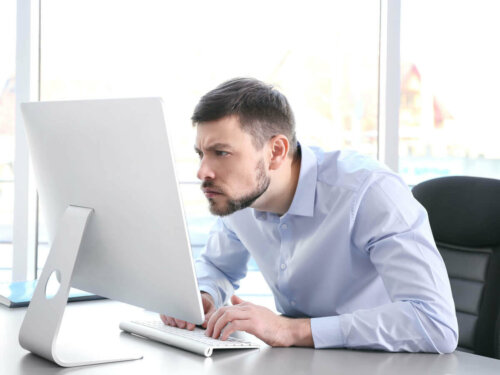 A man with bad posture at work.