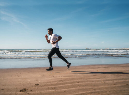 A man running down the beach.