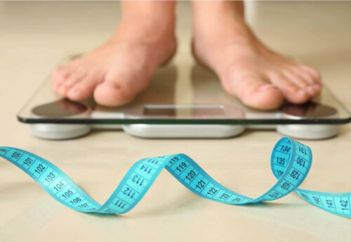 A person weighing themselves.
