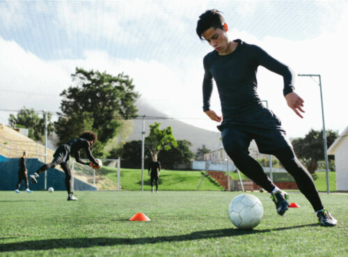 A soccer player kicking a ball.