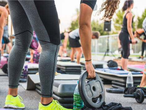 A woman using a disk weight