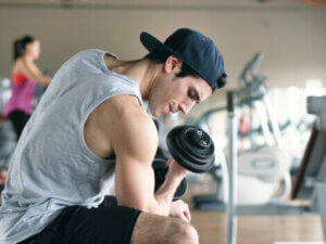 A man strength training with a dumbell.