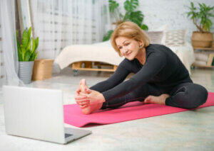 An older woman stretching at home.