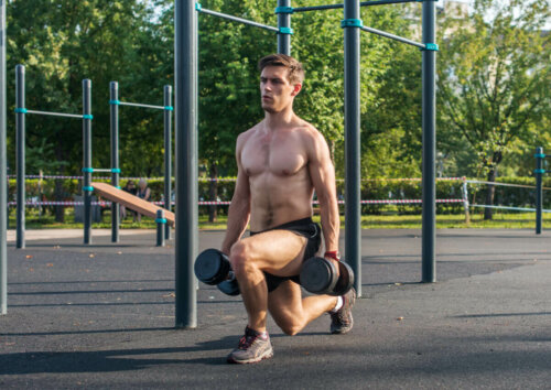 A man doing common dumbbell lunges outdoors.