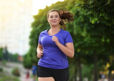 An overweight woman running