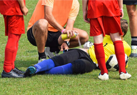 An athlete being treated on the field for hip pain