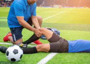 A trainer helping heal an injury.