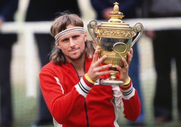 Bjorn Borji holding a tennis trophy.