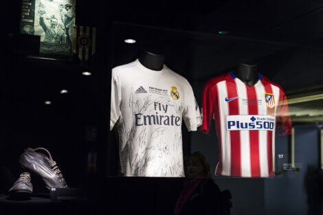 Two soccer jerseys on mannequins.