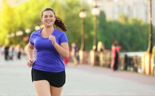 A woman jogging in the street.