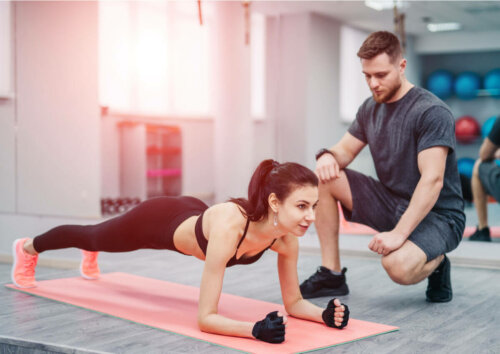 A woman exercising with her personal trainer.