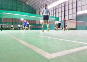 A badminton team on the court.