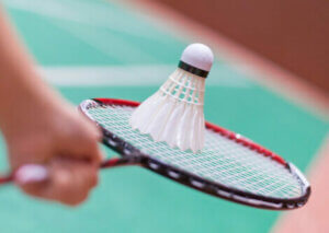 A birdie hitting the racket in badminton.