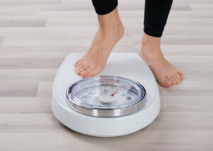 A person stepping on a scale.