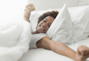 A woman doing her rest and recovery in bed.