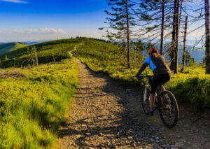 A woman riding her bike on a mountain.
