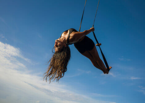 A girl doing an aerial fish pose.
