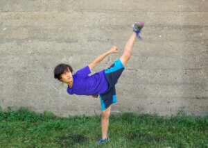 A child practicing taekwondo.