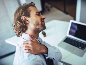 A man at work suffering from muscle spasms.
