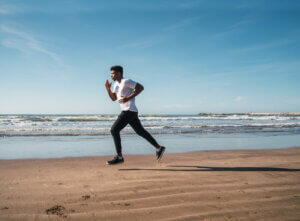 A man running on the beach.