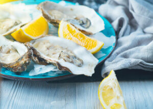 A plate of oysters and lemons.