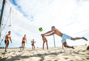 People playing beach volleyball.