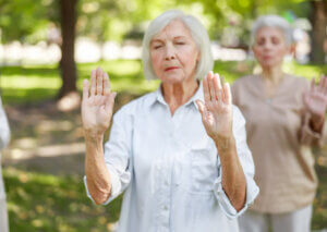 Woman practicing a Chi Kung exercise.