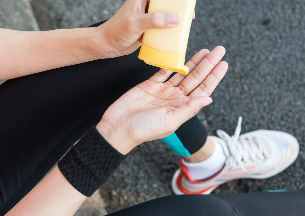 A person exercising and applying a cream.