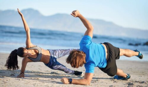 Exercises that Work the Core; couple doing side plank on the beach 