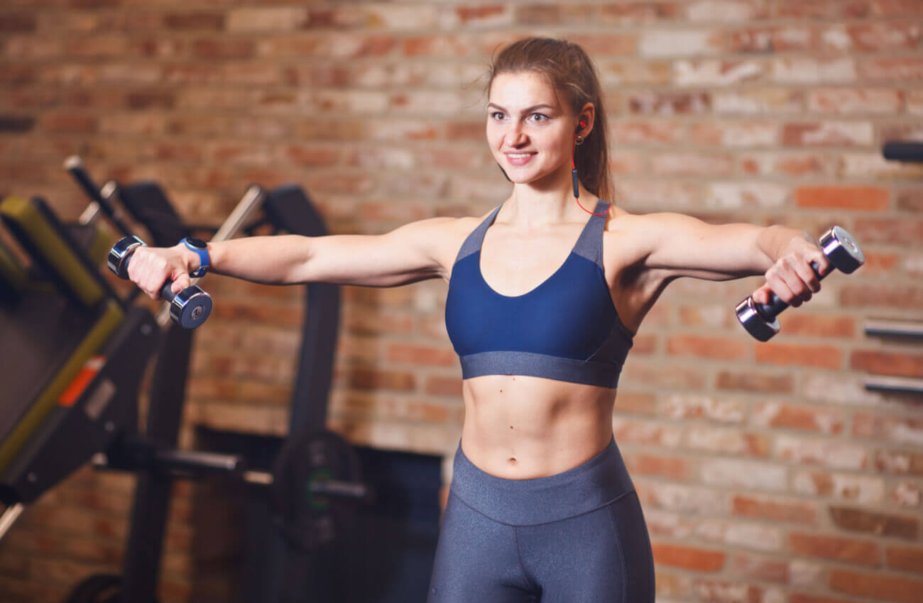 A woman lifting dumbbells.