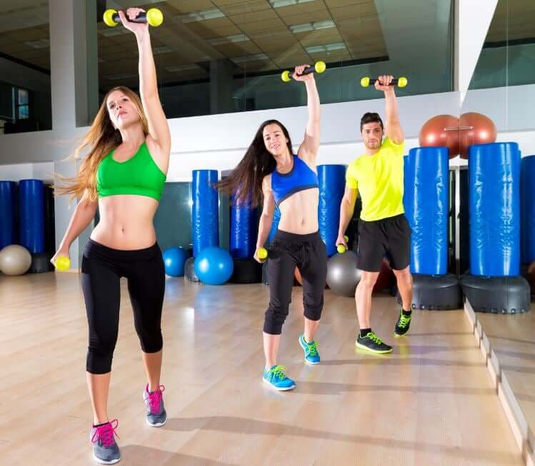 Women and men in a body pump class.