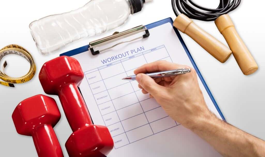 A person creating a workout plan on a calendar.
